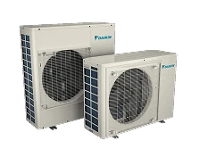 Two outdoor air conditioning units with visible fans, both labeled with the Daikin logo.