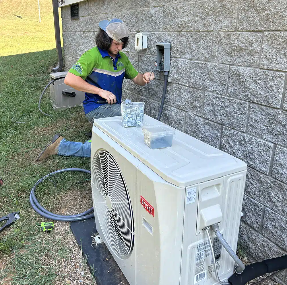 Top Notch technician installing Heat pump outside of residential home in Bowling Green, KY.