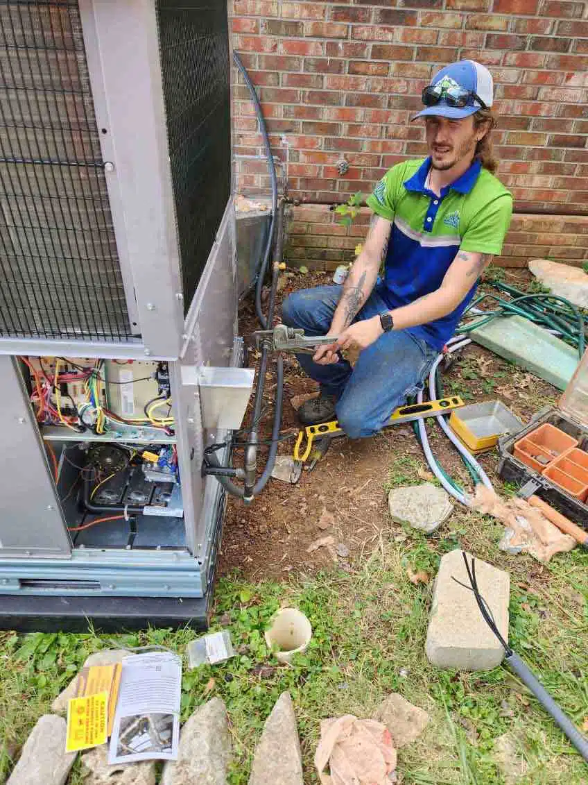 Technician working on HVAC system outside in BGKY.